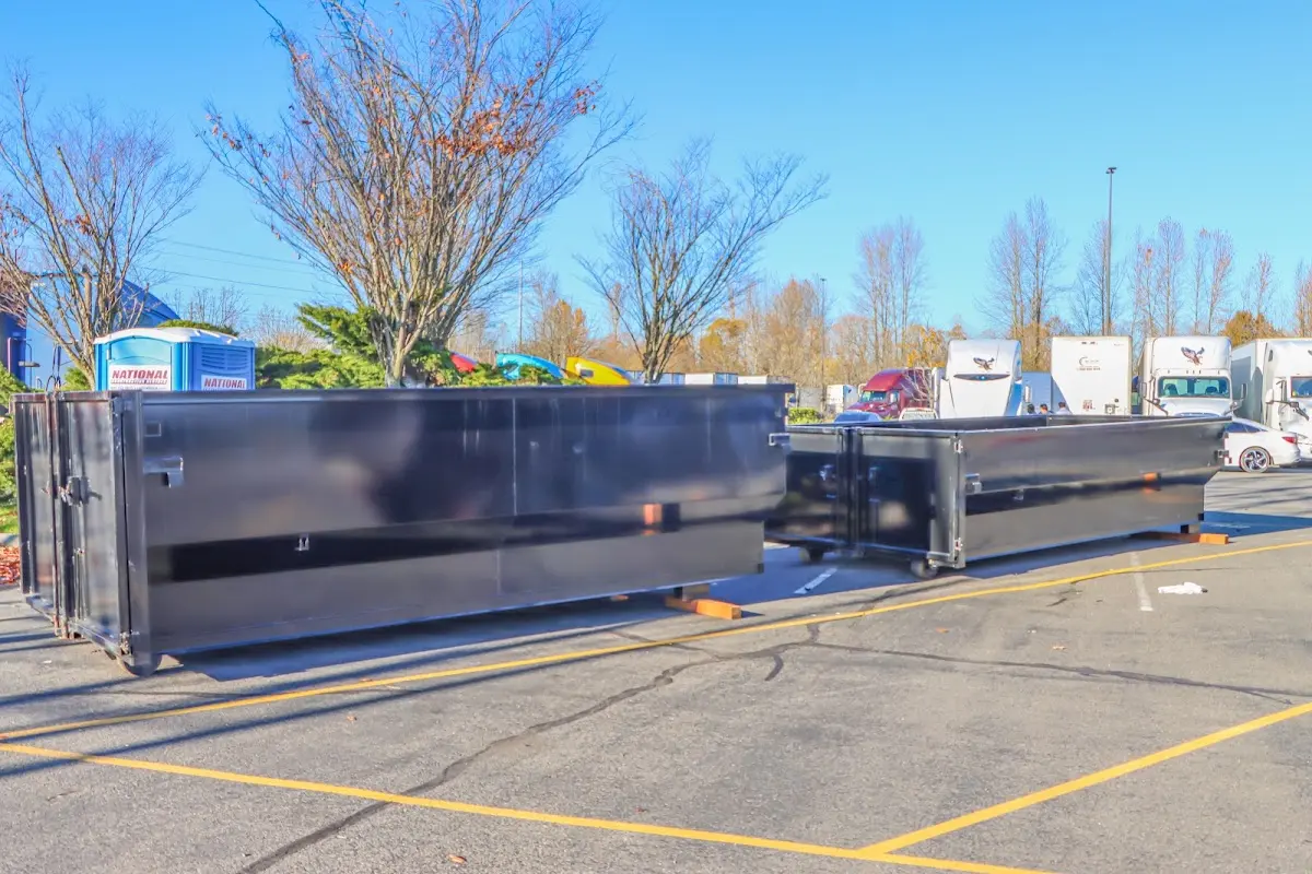 Professional dumpster rental service with roll-off container on residential driveway in Center